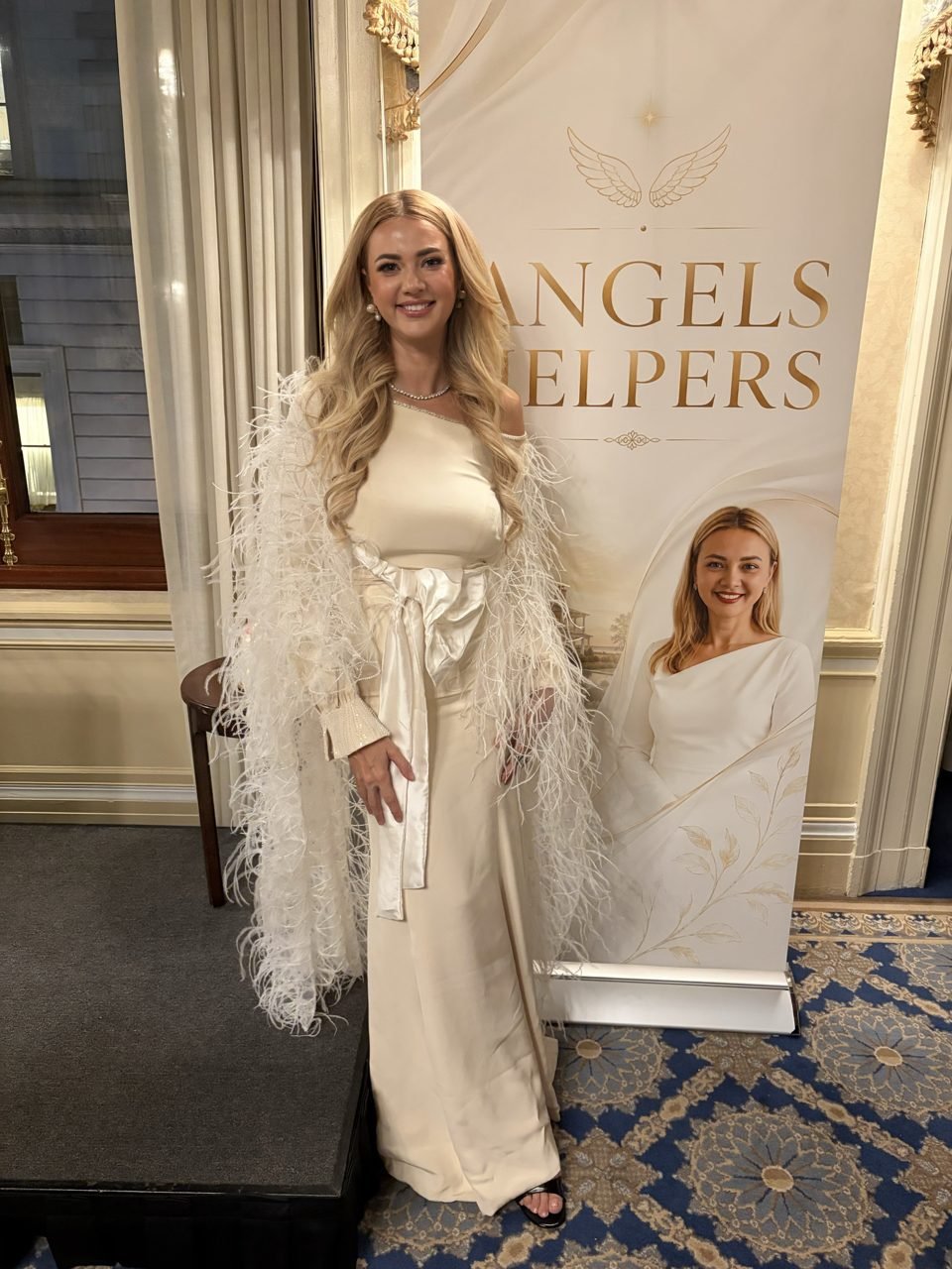 Alisa Roever at the Angel’s Helpers gala, beside the foundation’s backdrop.