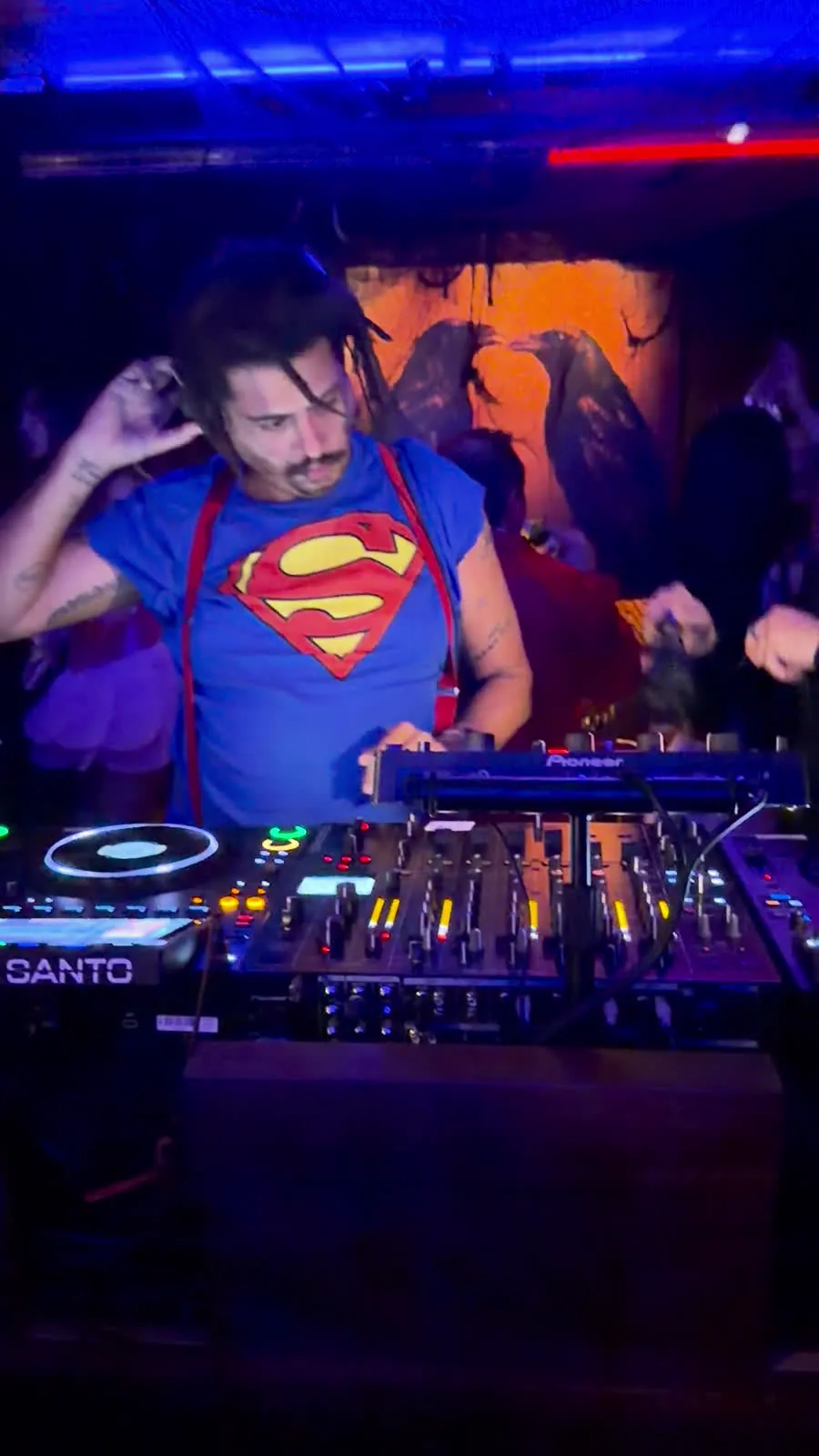 A DJ in a Superman costume at Crane Club’s Halloween party