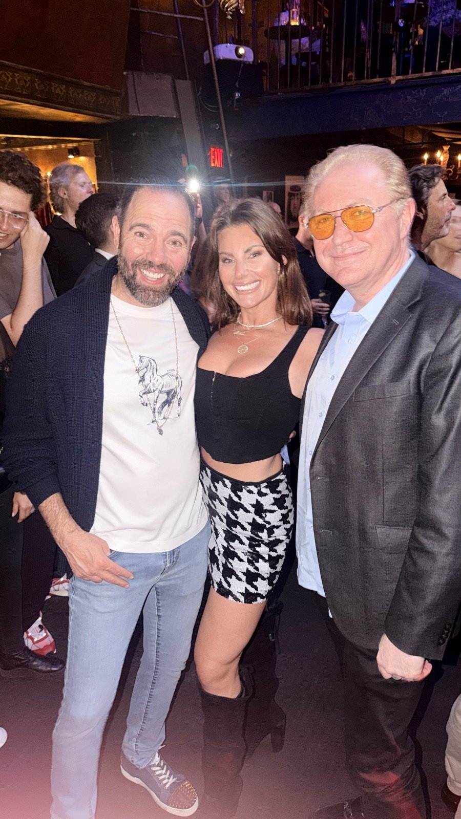 Three concertgoers photographed together inside The Cutting Room.