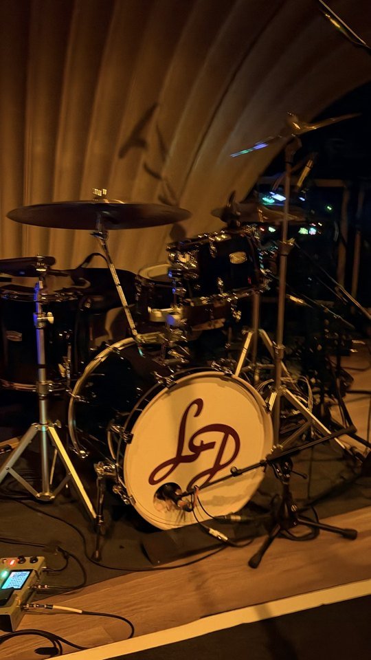 The Lady Delilah drum kit and curved stage backdrop.