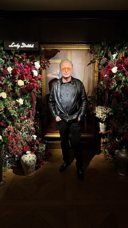A portrait beside the flower-framed Lady Delilah entrance.