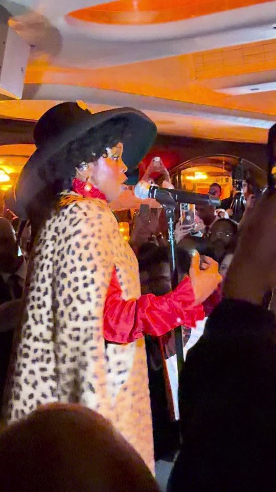 Lauryn Hill at the microphone during the opening-night performance. Video still.