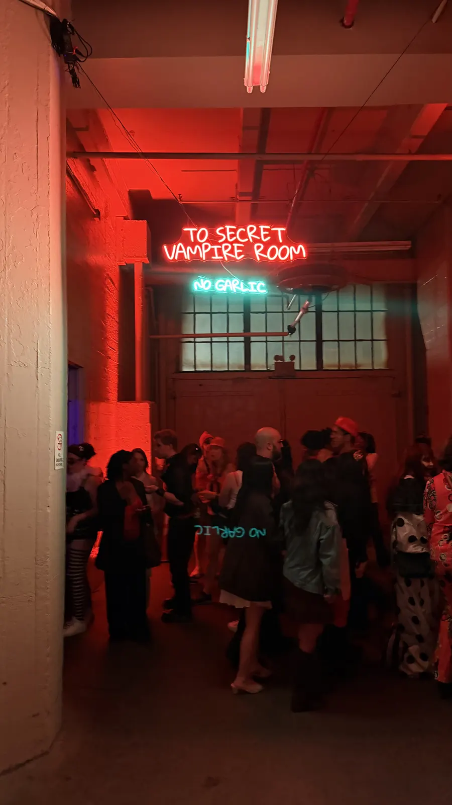 A neon sign points toward the Secret Vampire Room.