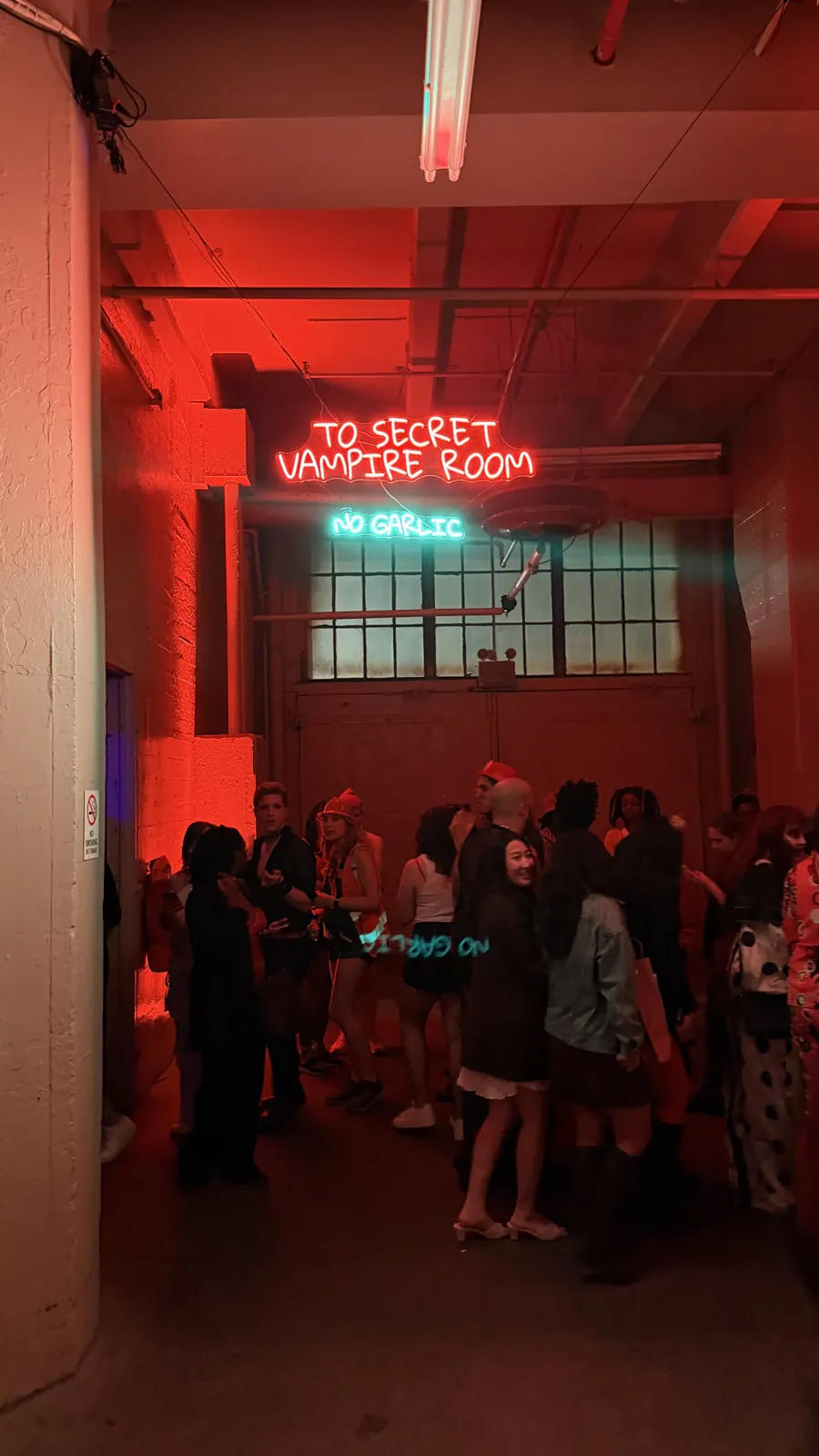Guests gather beneath the red-lit Secret Vampire Room sign.