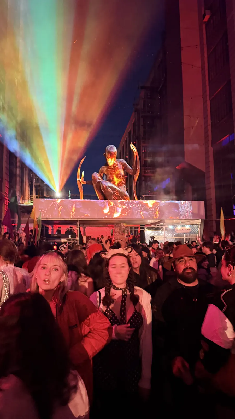 Light washes over the courtyard stage and costumed audience.