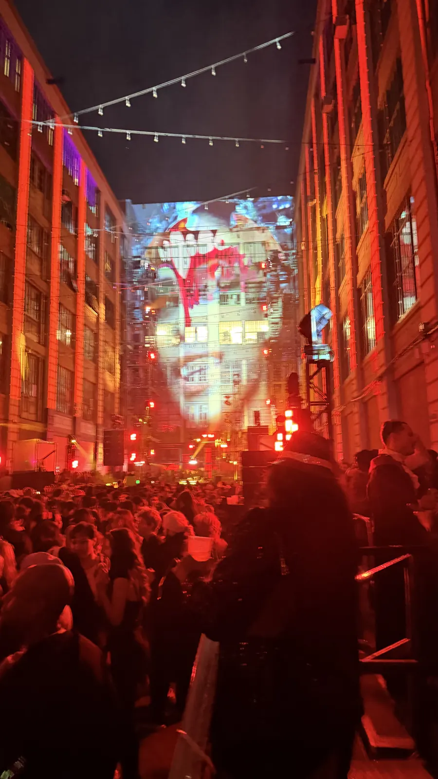 Illuminated brick façades and the courtyard crowd at the Vampire Ball at Industry City