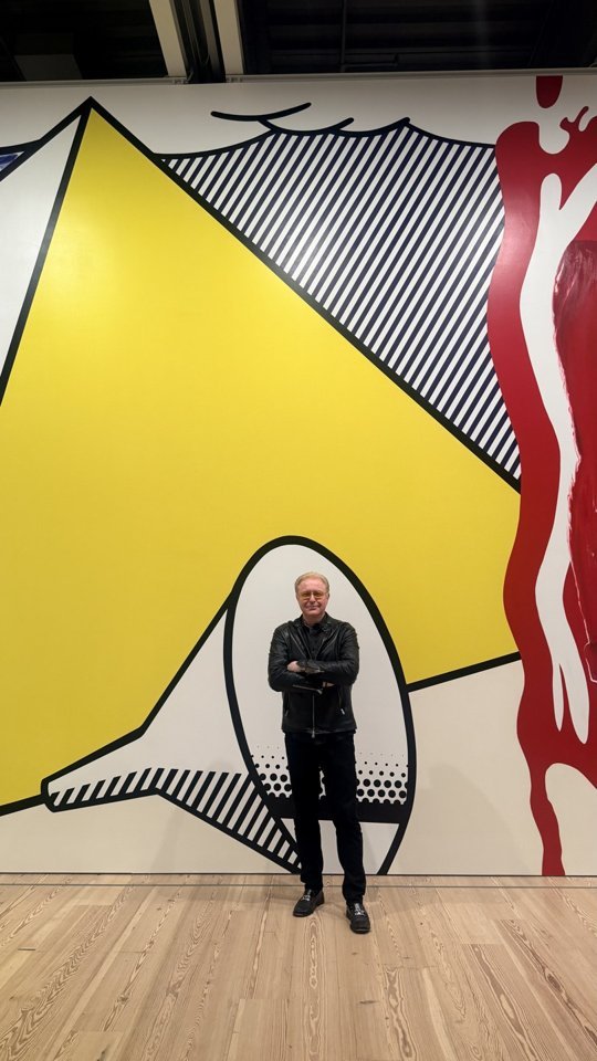 A visitor takes in the large-scale graphic work in the gallery.