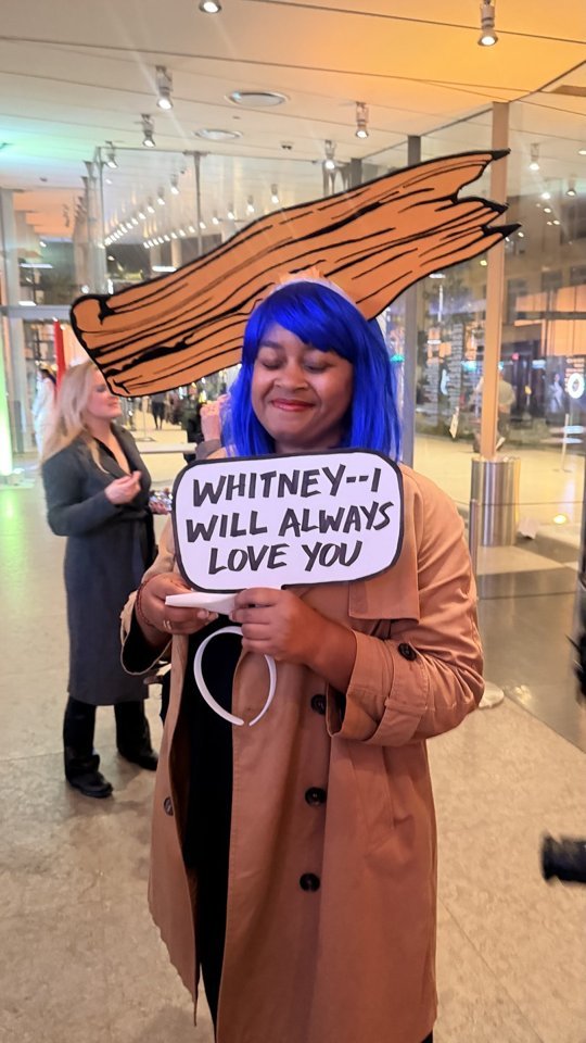 A blue wig and a Whitney speech-bubble prop bring the Pop theme into the party.